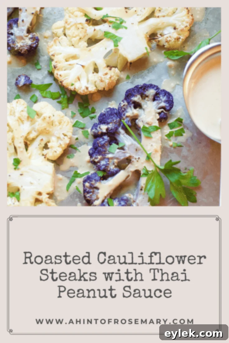 Tall shot of Roasted Cauliflower Steaks with Thai Peanut Sauce