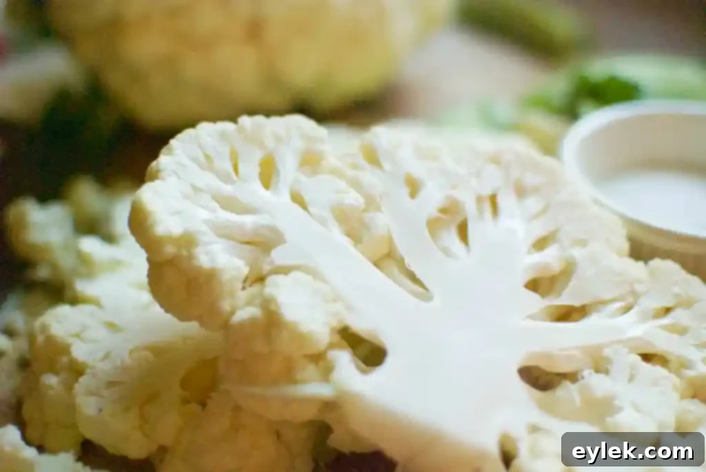 Roasted Cauliflower Steaks with Thai Peanut Sauce on a baking sheet
