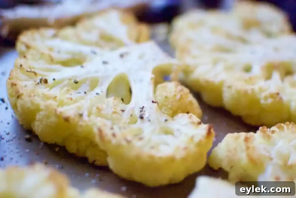 Roasted cauliflower steak being tested for doneness