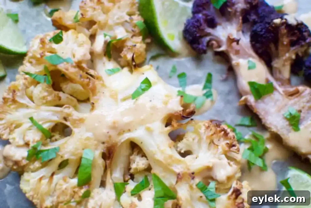 Side view of roasted cauliflower steaks with sauce