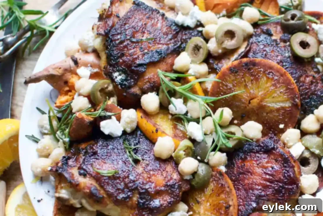 Close-up of a portion of Charred Chicken with Sweet Potatoes & Oranges, showing the crispy skin and juicy chicken
