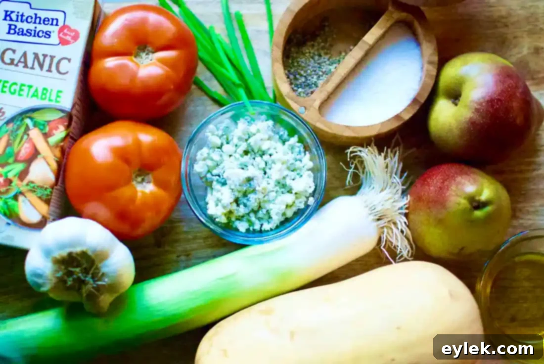 Delicious Roasted Pear & Butternut Squash Bisque garnished with chives and blue cheese