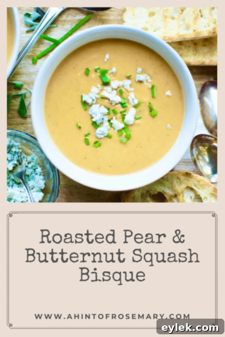 Vertical shot of Roasted Pear & Butternut Squash Bisque with a garnish of chives and blue cheese
