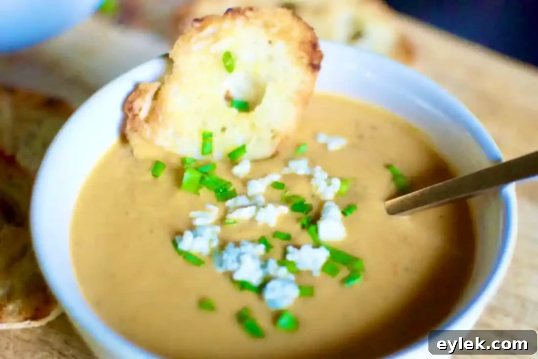 Two bowls of Roasted Pear & Butternut Squash Bisque on a wooden table