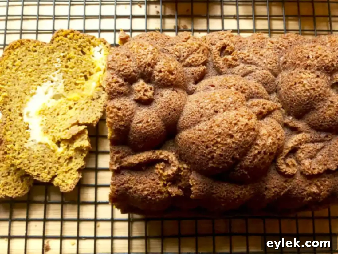 Two enticing slices of gluten-free pumpkin bread with a visible cream cheese swirl