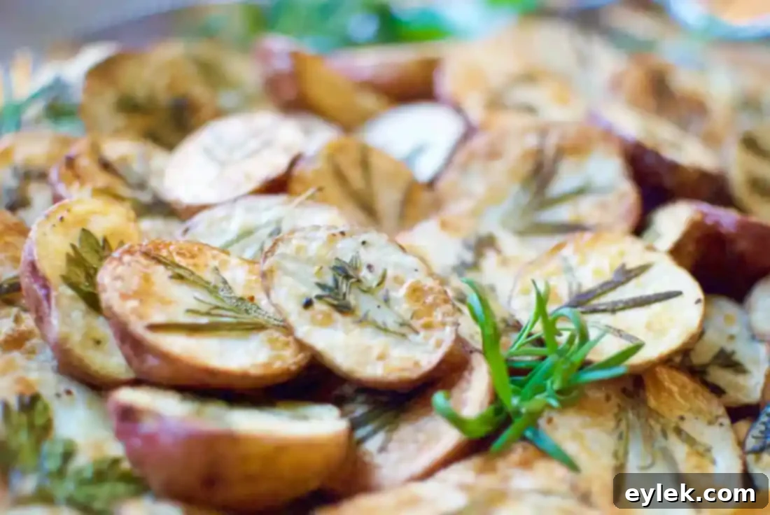 Pile of Dressed-Up Herb Roasted Potatoes in a serving bowl