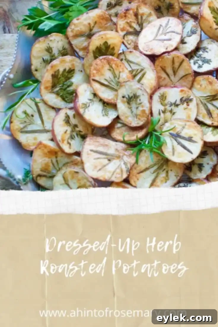 Dressed-Up Herb Roasted Potatoes on a serving board with a sprig of fresh rosemary