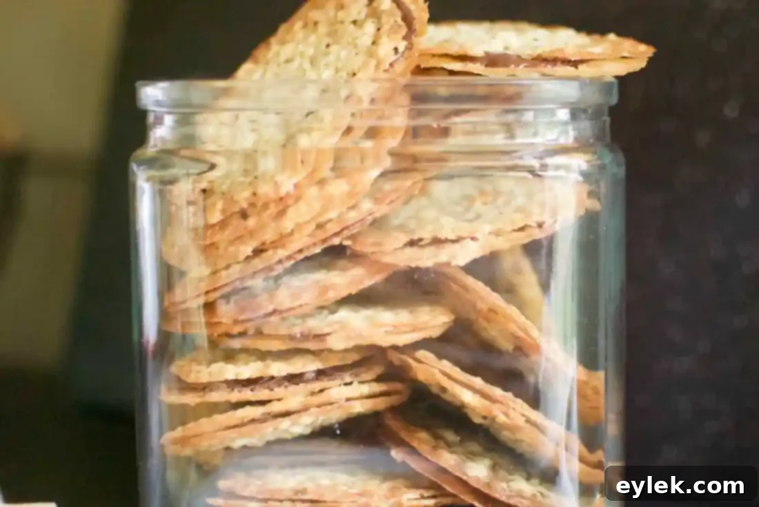 chocolate lace sandwich cookies stacked in container