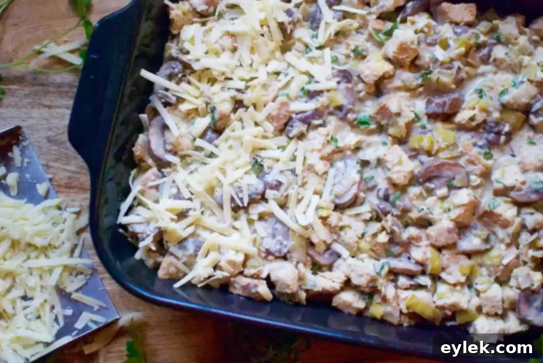 bread pudding mixture in baking dish with cheese on top
