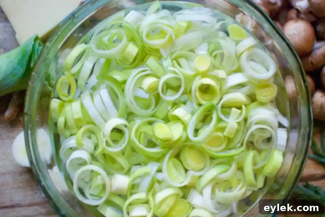 sliced leeks being rinsed for bread pudding