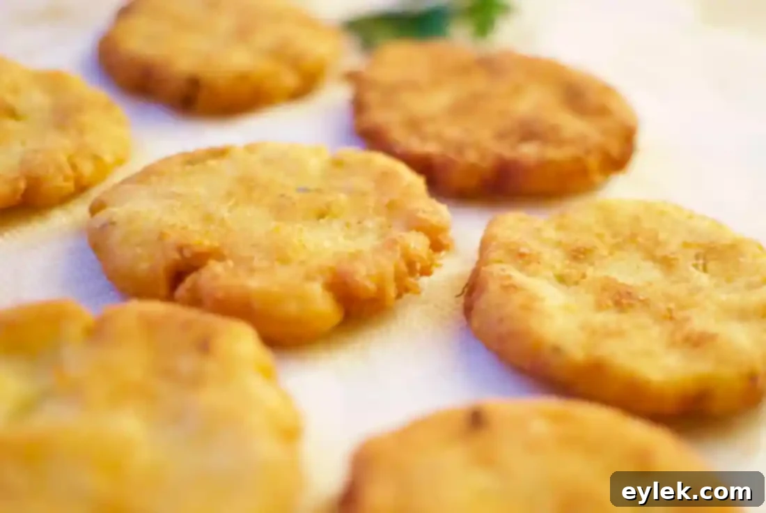 Golden brown and crispy potato pancakes frying in a skillet, ready to be served.