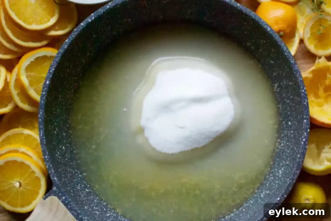 Syrupy mixture simmering in a skillet, ready for orange slices