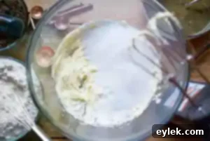 Softened butter being beaten in a mixing bowl