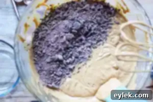Adding flour mixture to the wet ingredients for gingerbread cake