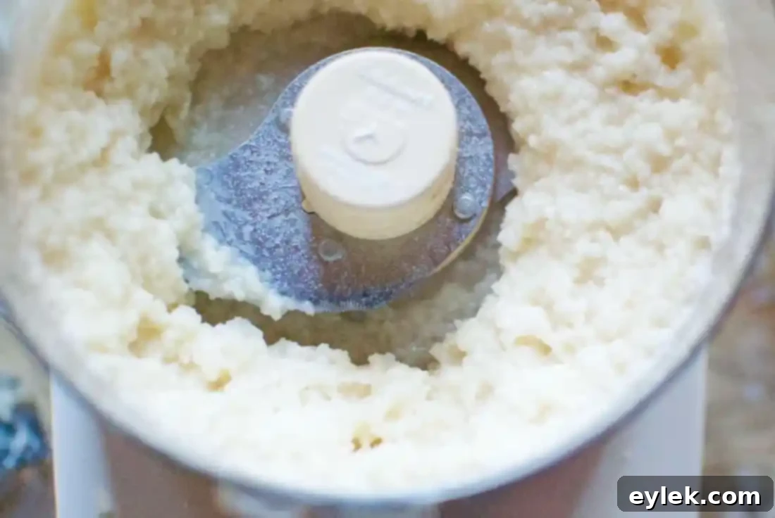 Rolling macaroons in coconut