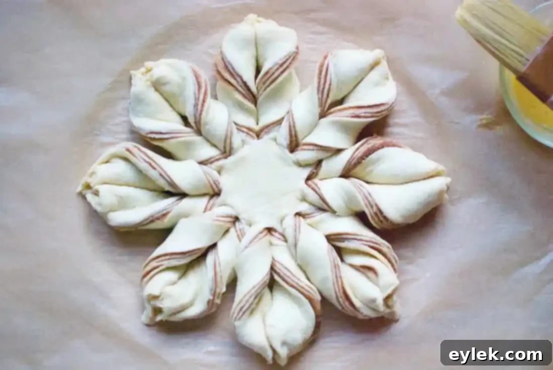 Cinnamon Star Bread proofing on a baking sheet