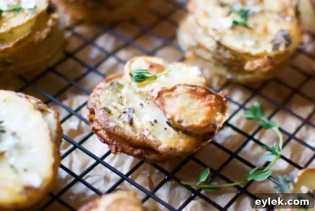 Cheesy potato and herb stacks arranged on a platter, ready to be served.