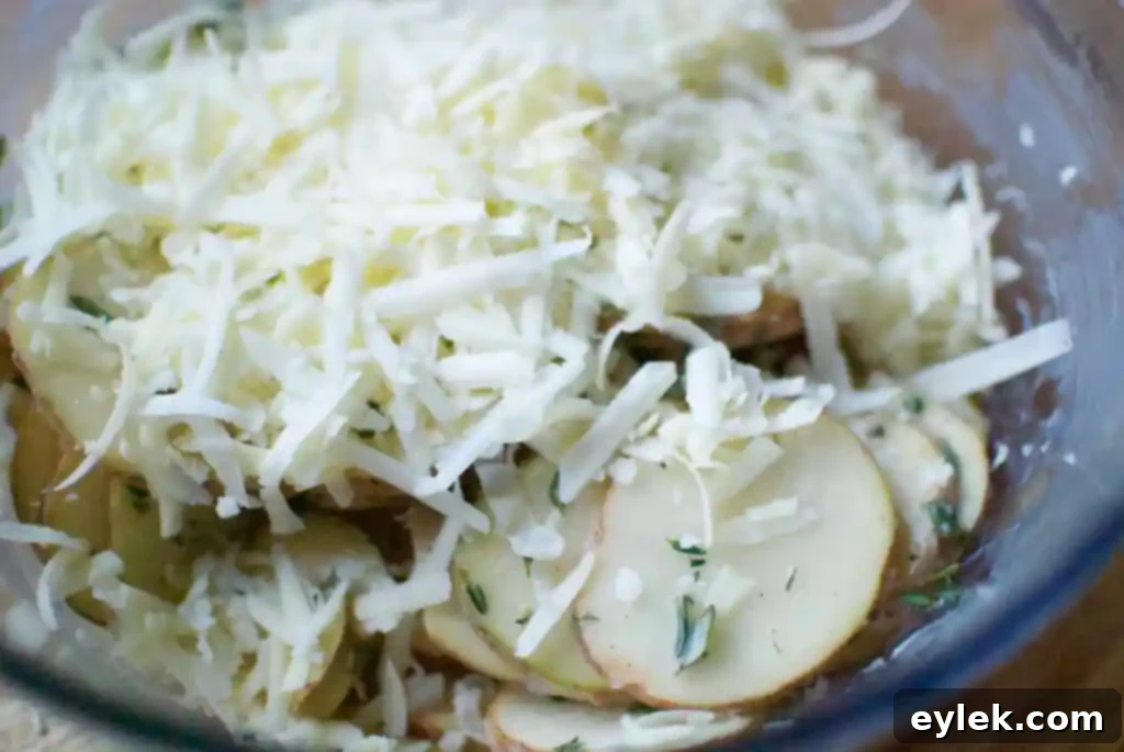 Cheesy potato and herb stacks expertly arranged in a muffin tin, ready for baking.
