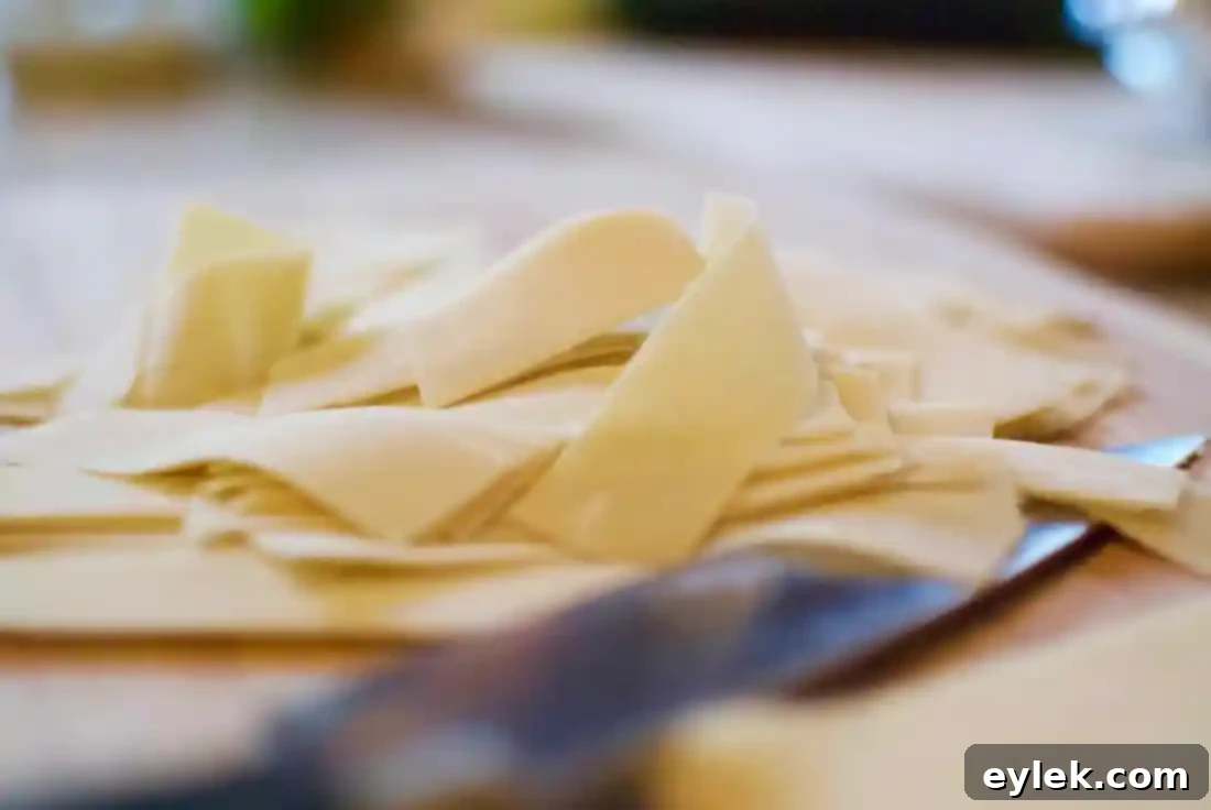 Close-up of wonton wrappers pressed into muffin tin cups, forming the base for the Italian egg cups.