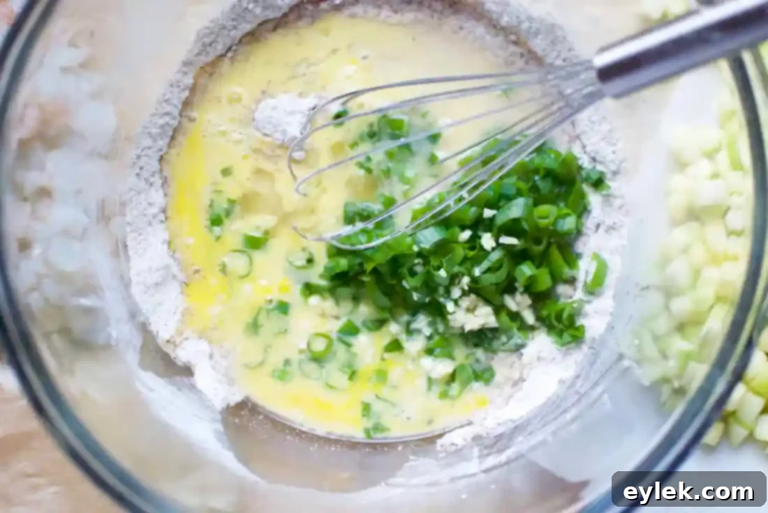 Mixing fritter batter with almond and arrowroot flours