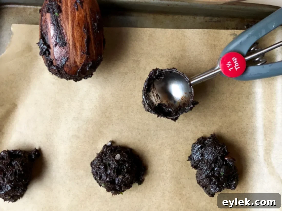 Scooped and flattened cookie dough on a baking sheet