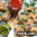 Golden Crispy Cheese Ravioli 11 Crispy Fried Ravioli served on a platter with dipping sauces