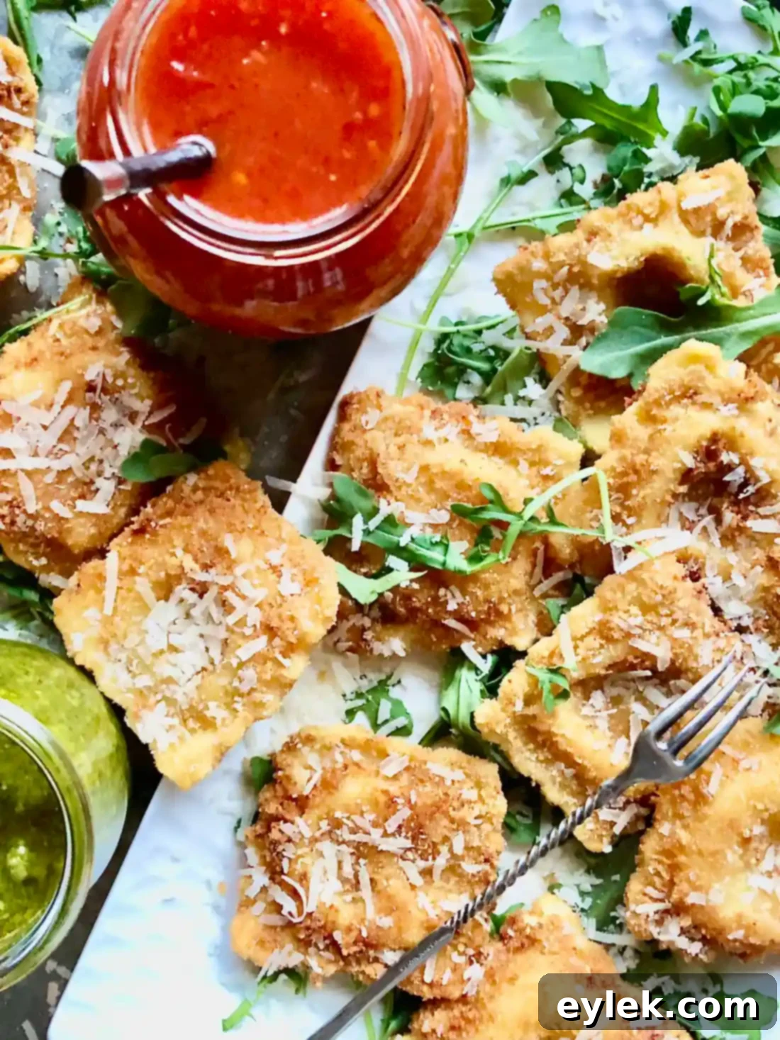 Crispy Fried Cheese Ravioli - Vertical shot with text overlay and dipping sauces
