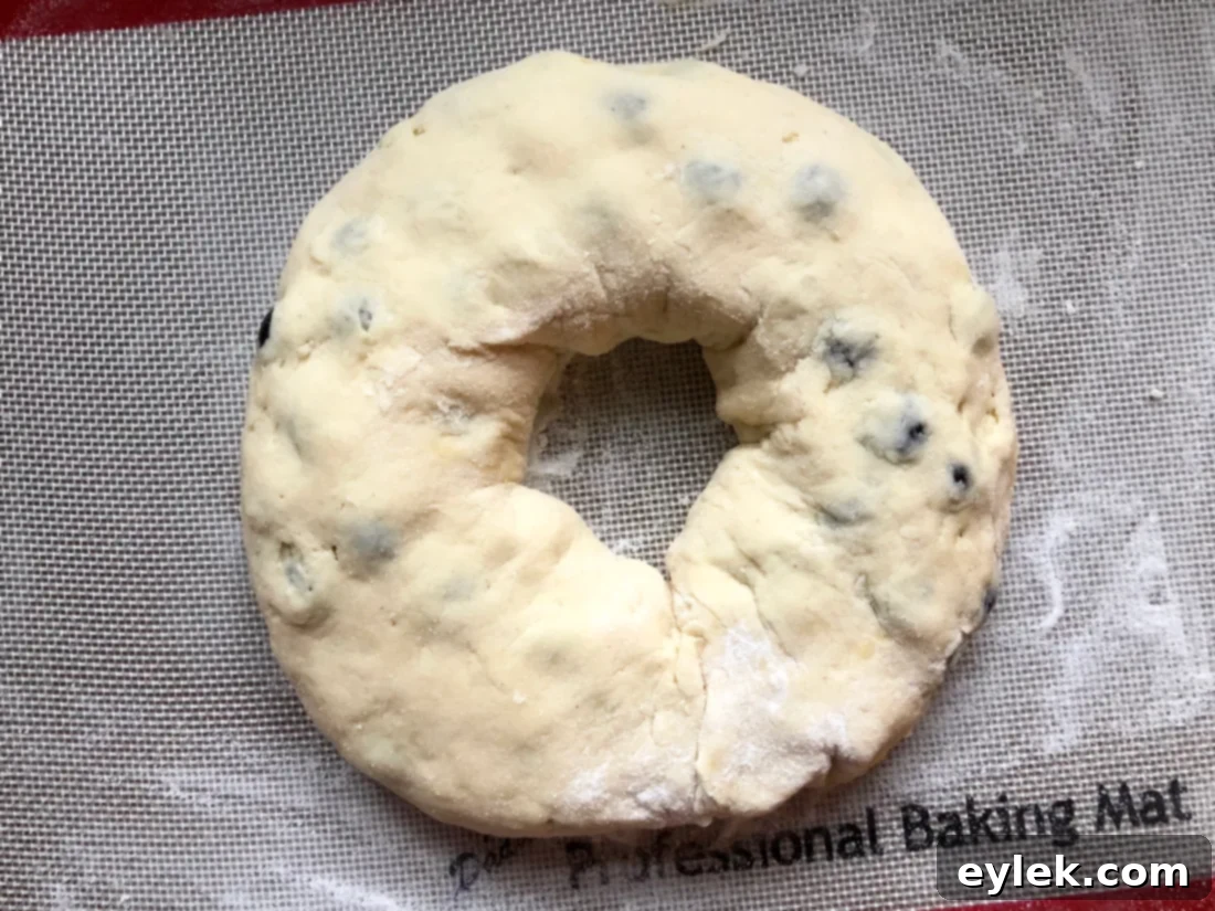Gluten-Free Blueberry & Lemon Curd Ring shaped and resting on parchment paper before baking.