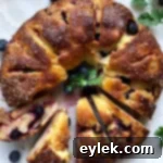 A freshly baked Gluten-Free Blueberry & Lemon Curd Ring, golden and inviting.