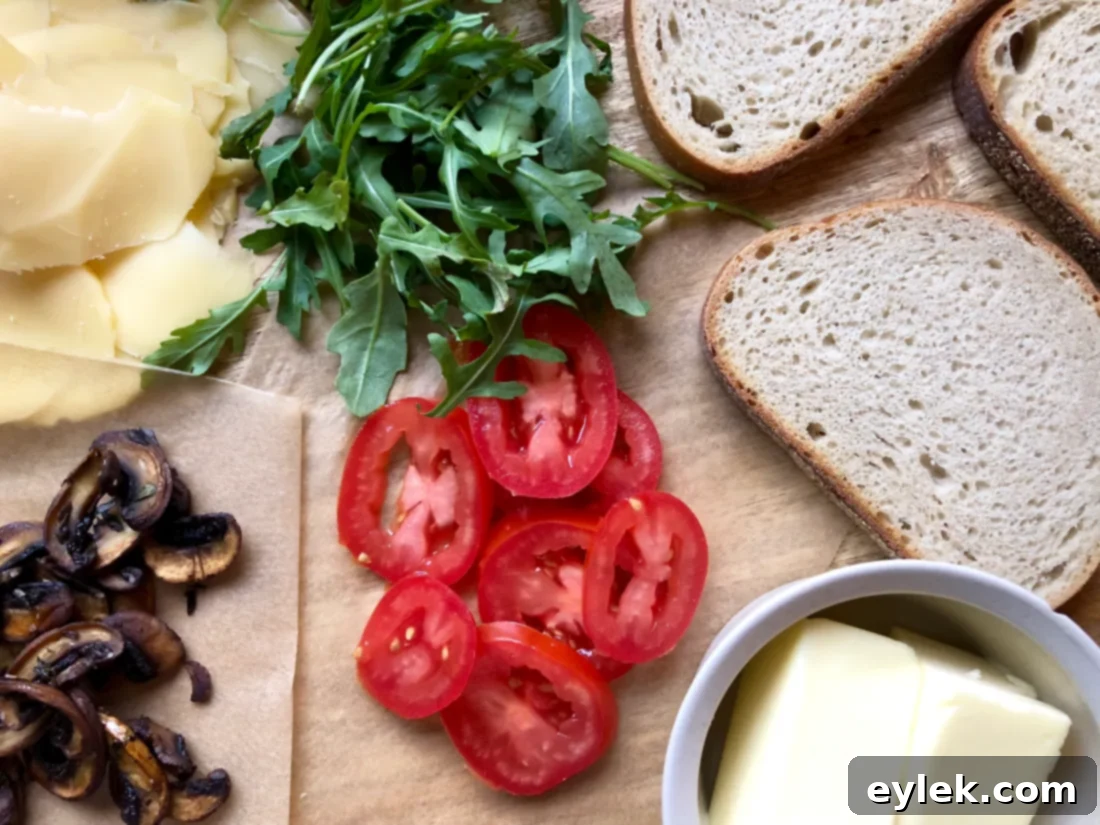 Layering smoked gouda and vegetables on rye bread