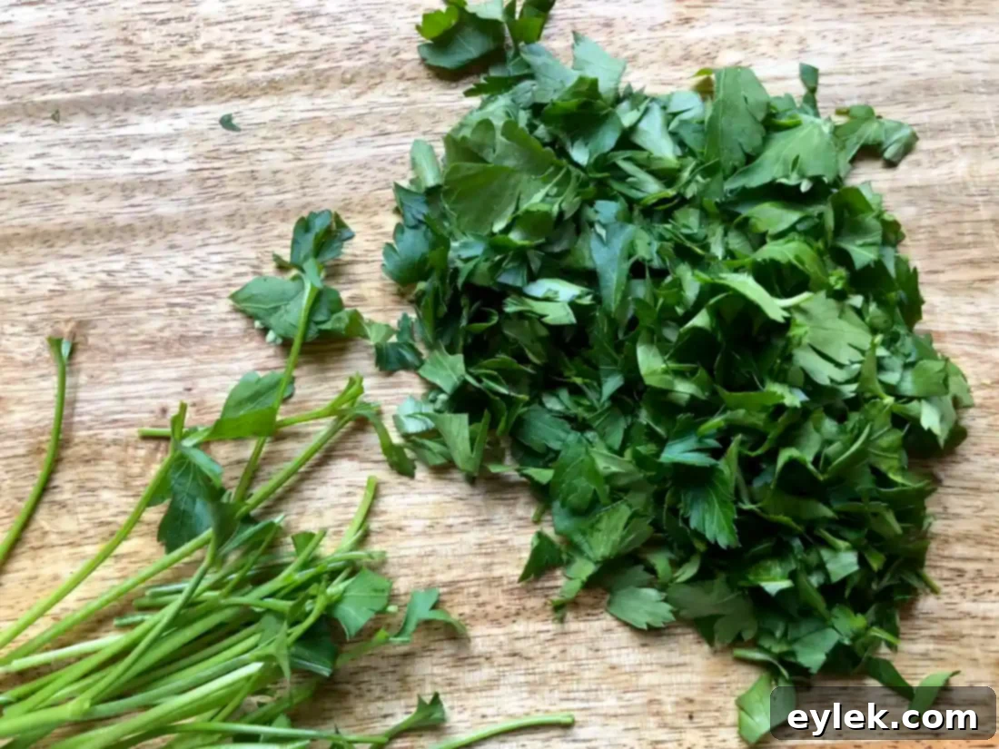 Sliced leeks and chopped parsley added to the sautéed vegetables in the pot.