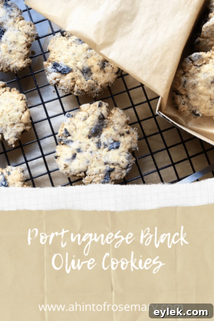 Stacked Portuguese Black Olive Cookies with olives and oranges.