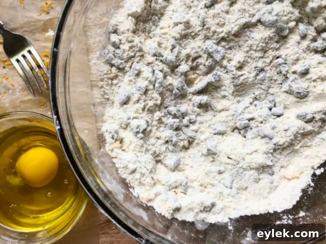Dough balls for Portuguese Black Olive Cookies being rolled in sugar.