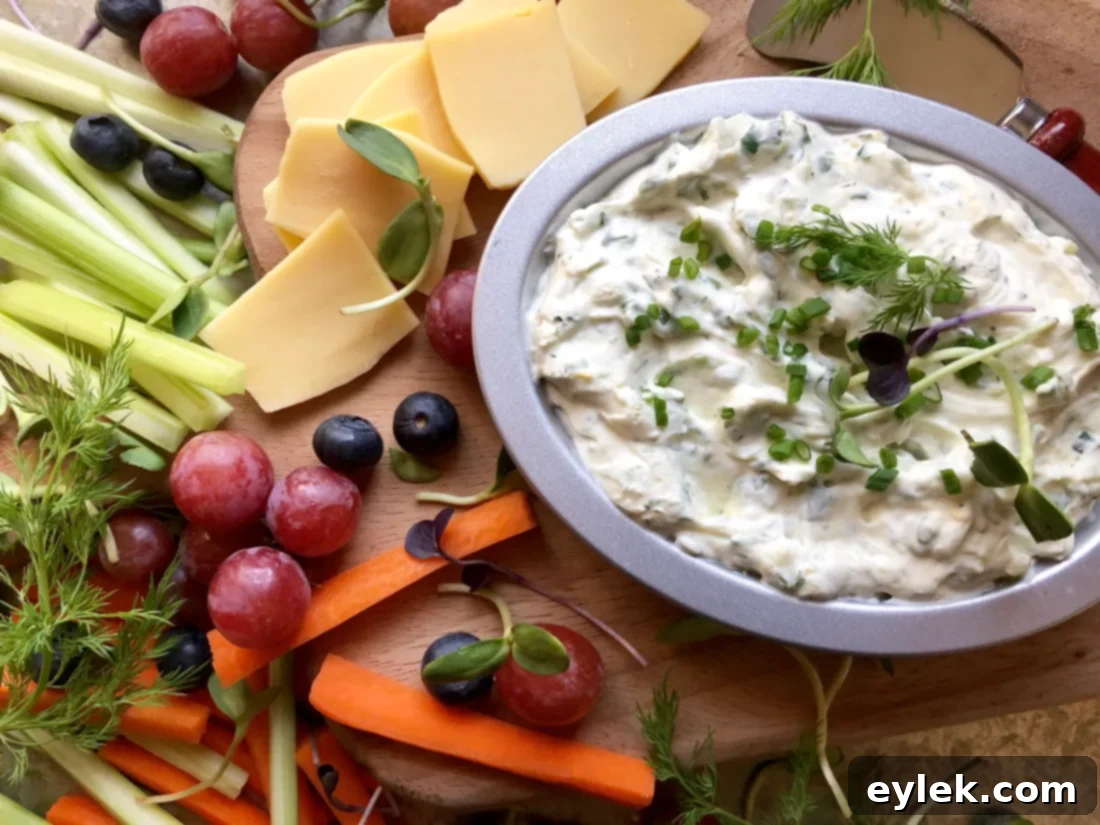 Serving bowl of creamy herbed dip with fresh vegetables