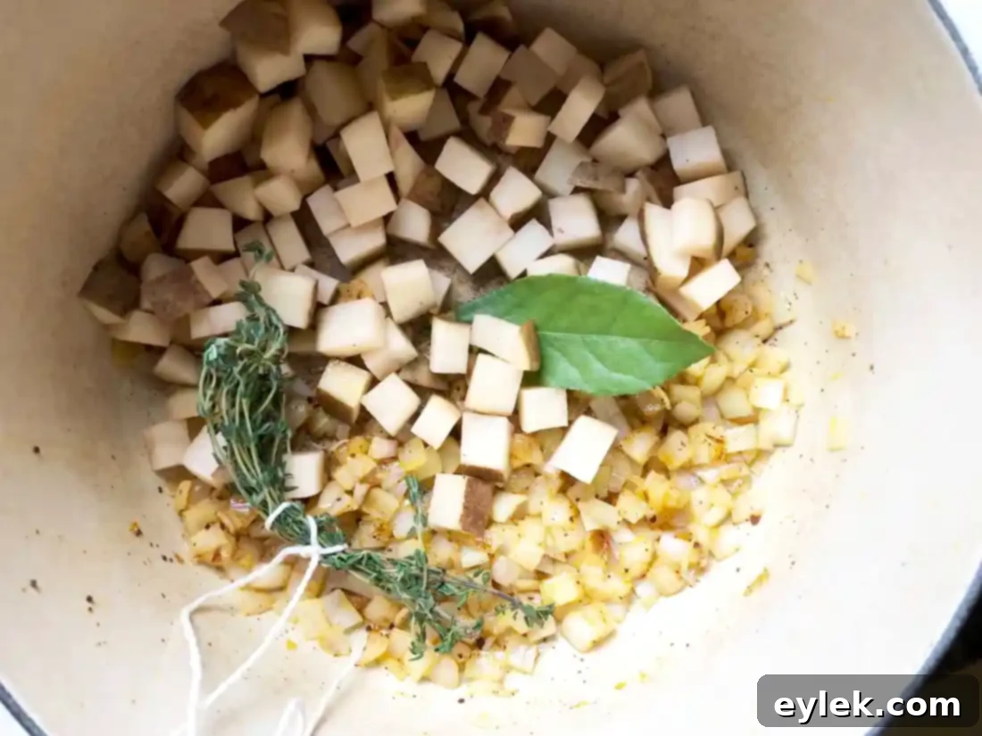 potatoes, bay leaf, and thyme bundle added to chowder