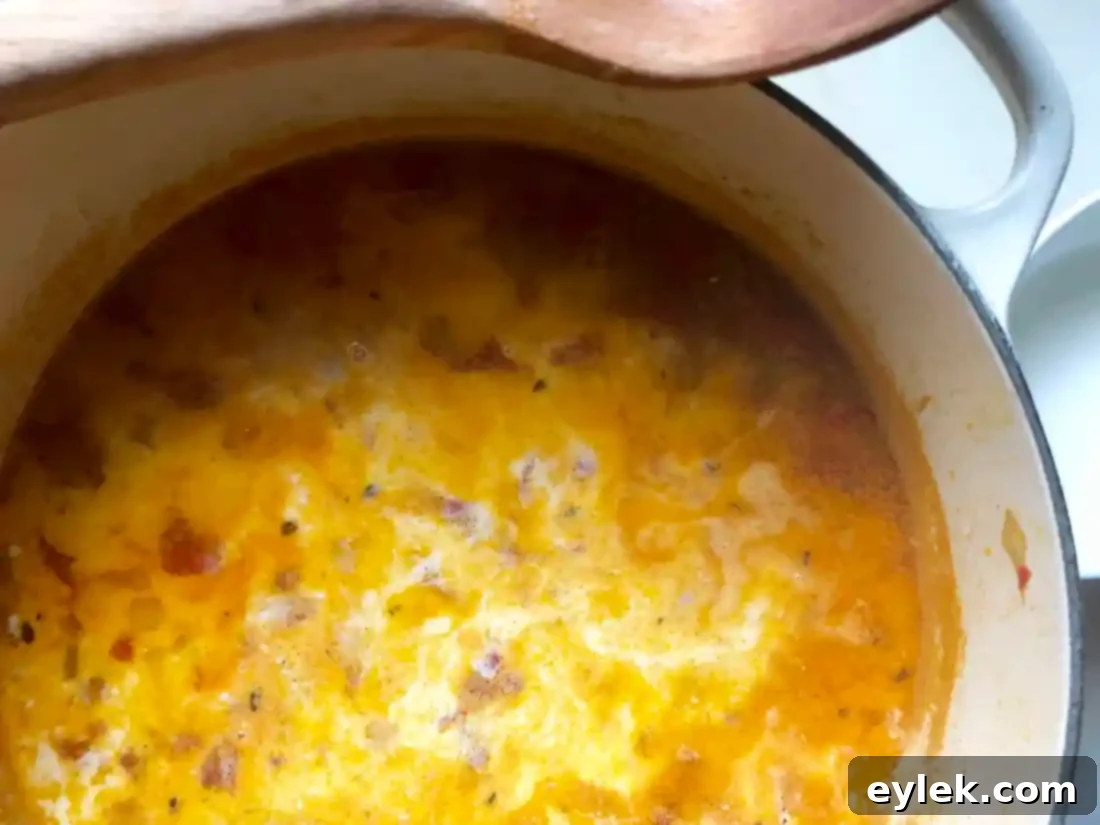 finishing Blushing Seafood Chowder with cream