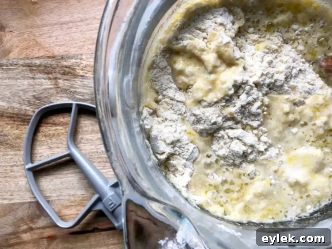 A close-up of mixed gluten-free pizza dough, resembling a thick cake batter.
