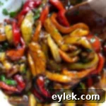 Zesty Marinated Roasted Peppers 11 Marinated roasted bell pepper strips in a glass bowl with herbs