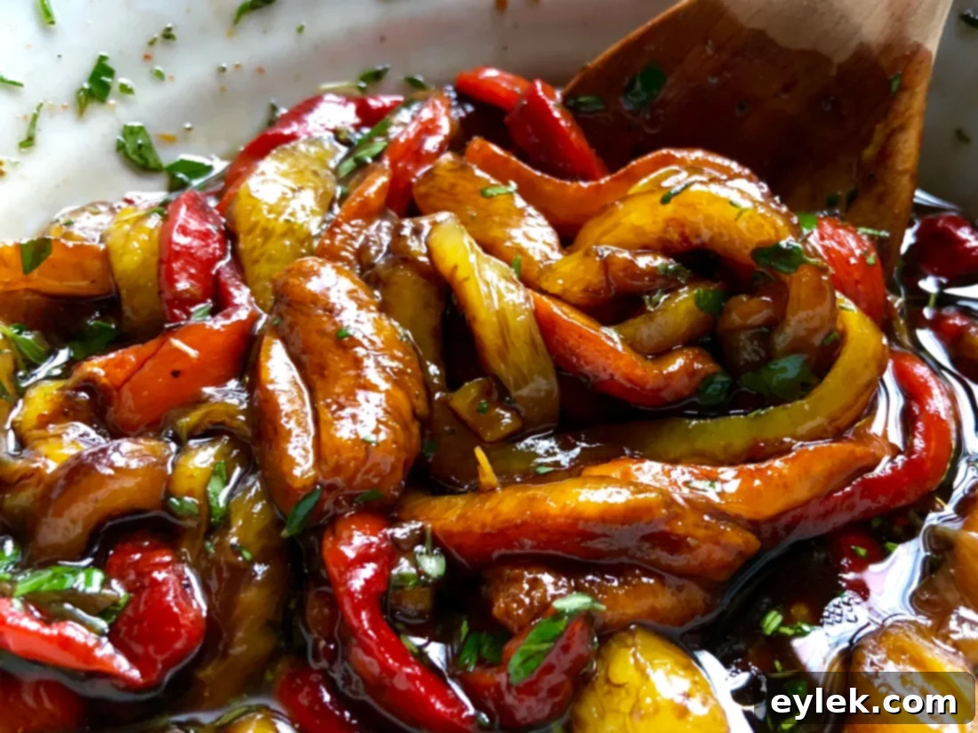 Marinated roasted bell pepper strips arranged in a serving bowl