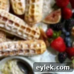 Irresistibly Crispy Waffle Sticks 17 Plate of golden waffle sticks with powdered sugar