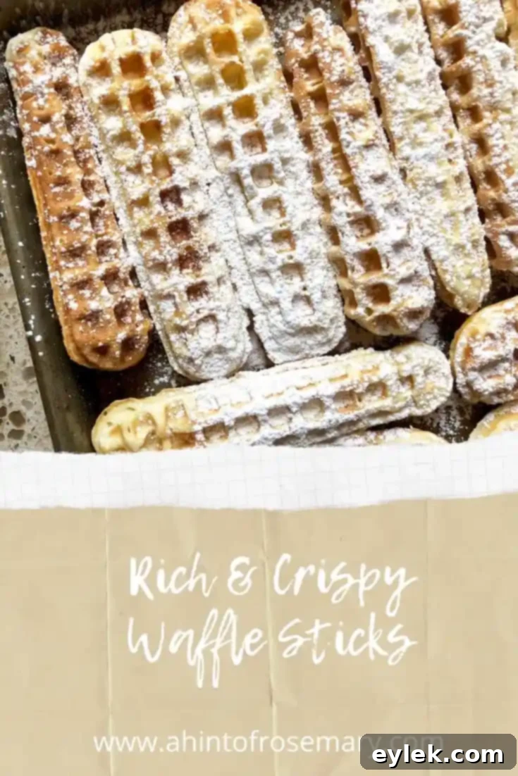 Waffle sticks arranged artistically with fresh fruit, topped with powdered sugar
