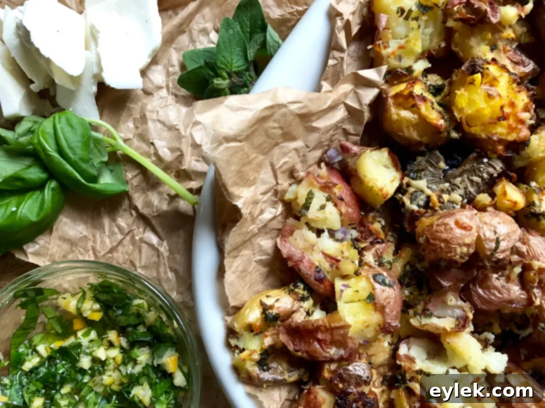 Plated crispy smashed potatoes drizzled with lemon-basil mixture and topped with feta