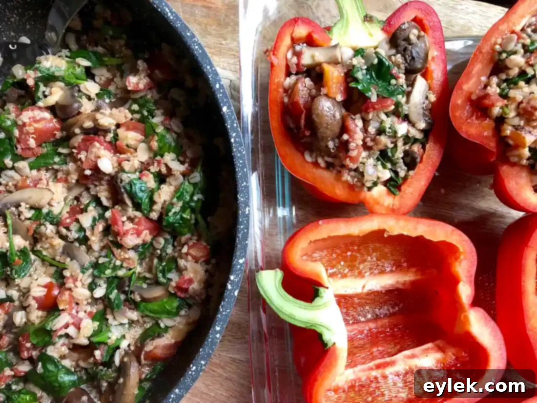 Filling bell peppers with quinoa and spinach mixture
