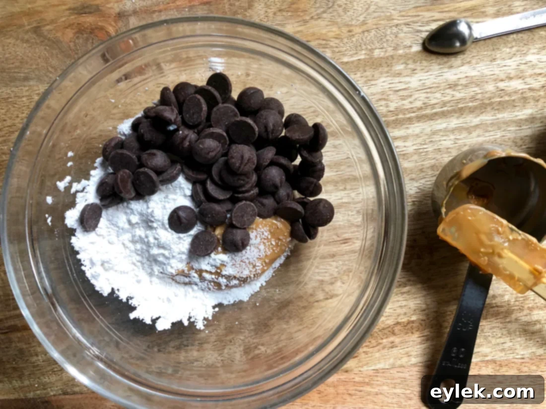 The peanut butter chocolate filling being stirred until smooth and melted, ready for chilling.