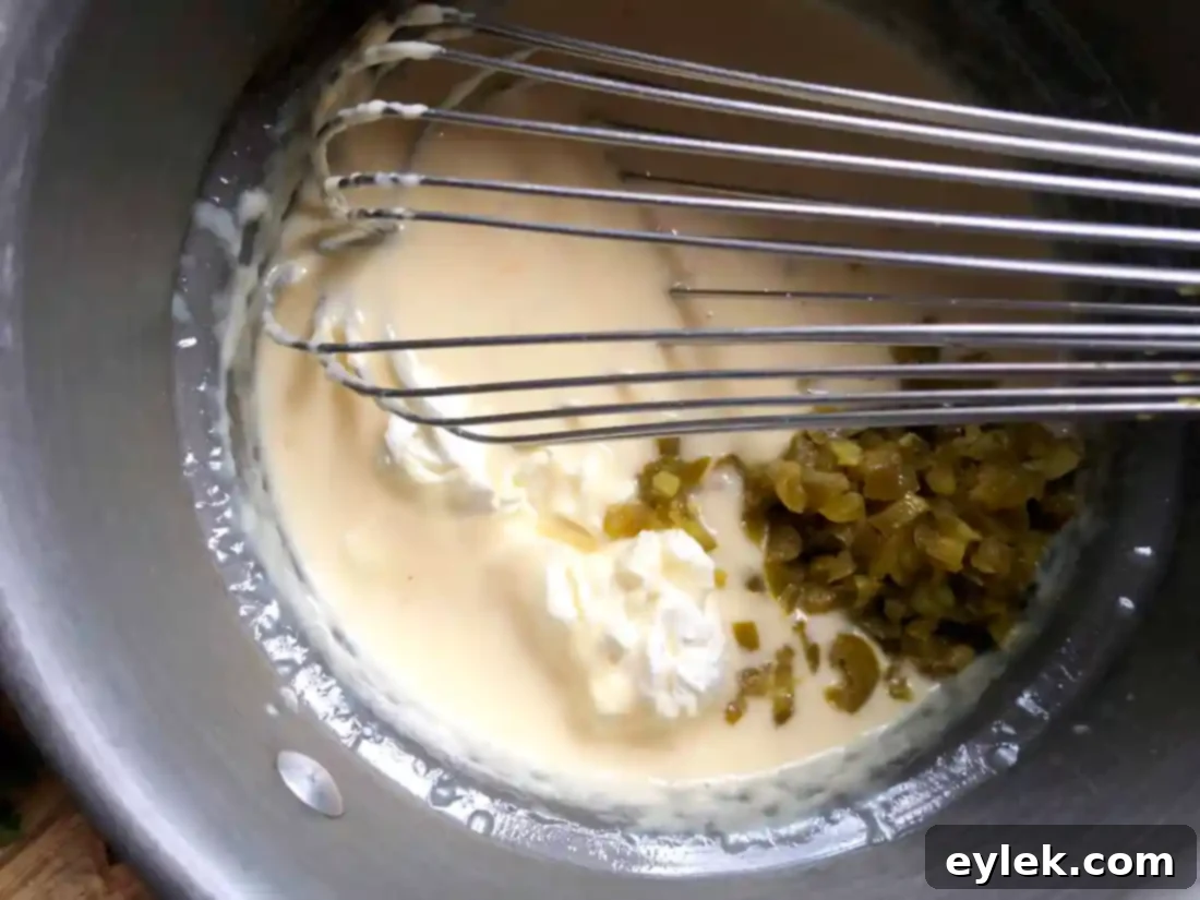 Whisking cheese and milk for queso