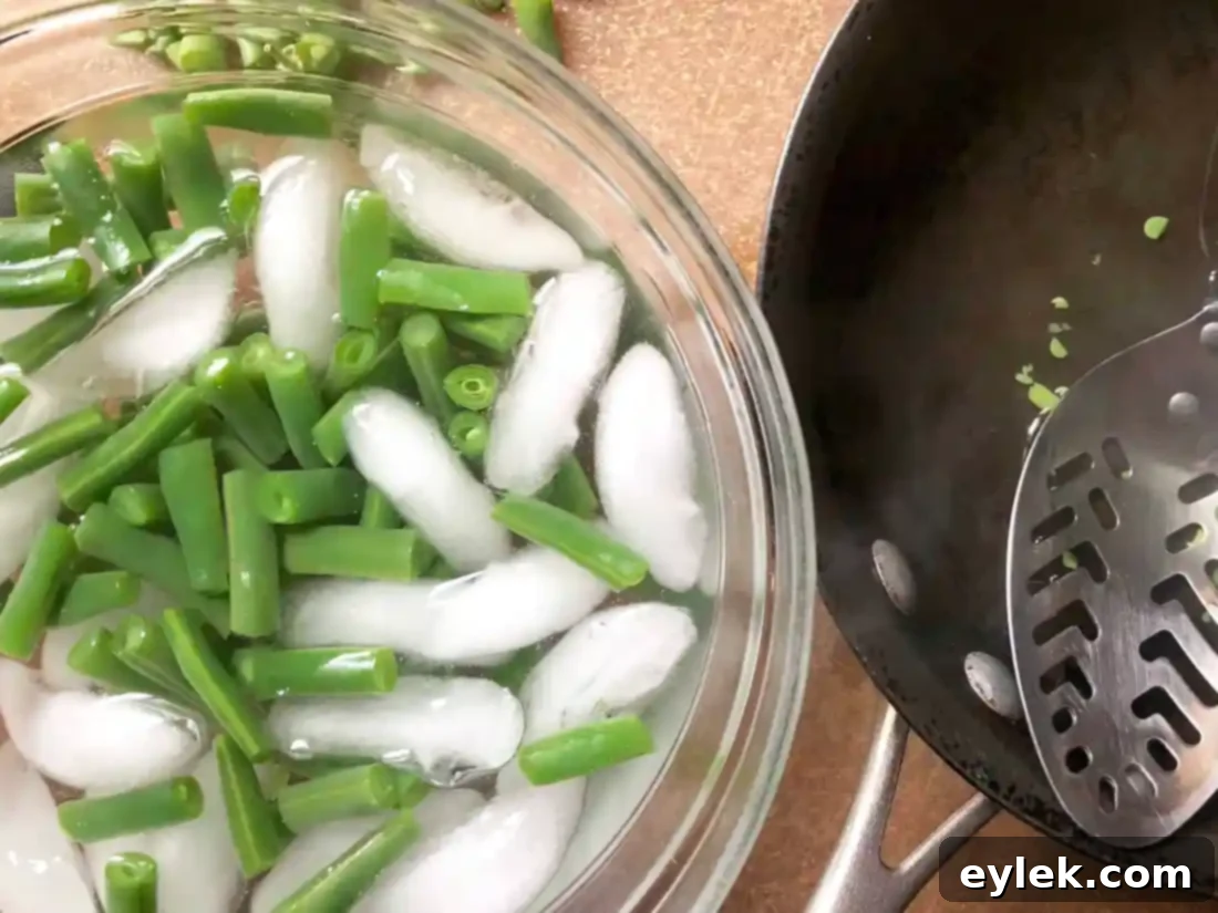 diced vegetables, including onions, peppers, and tomatoes, prepared for roasting