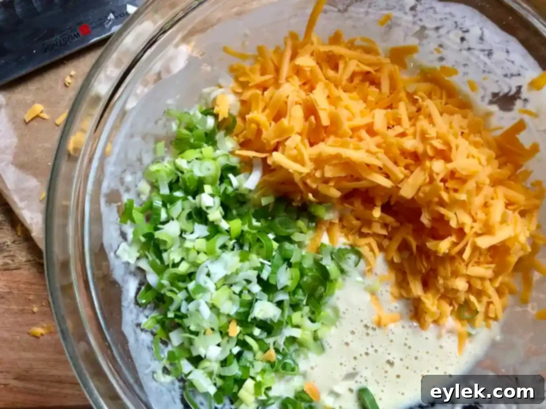 Green Onion & Cheddar Popovers batter in muffin tin