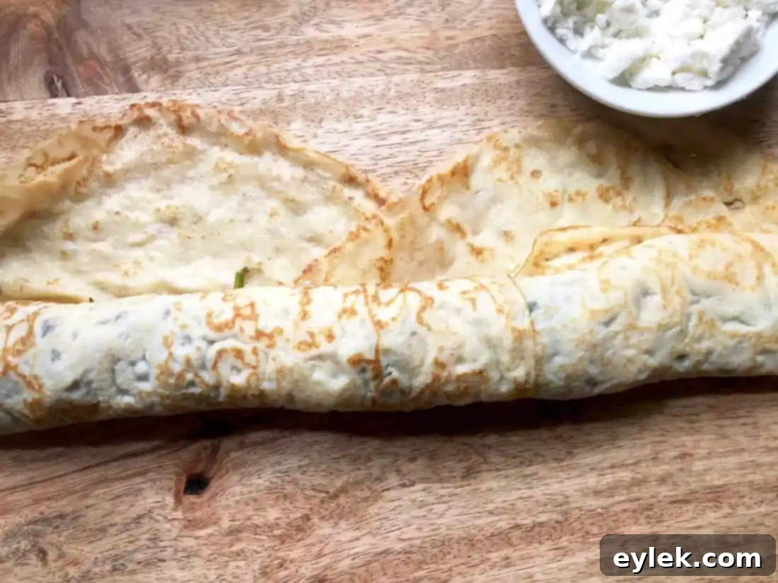 Assembling Savory Crepe Egg Rolls: adding filling and cheese