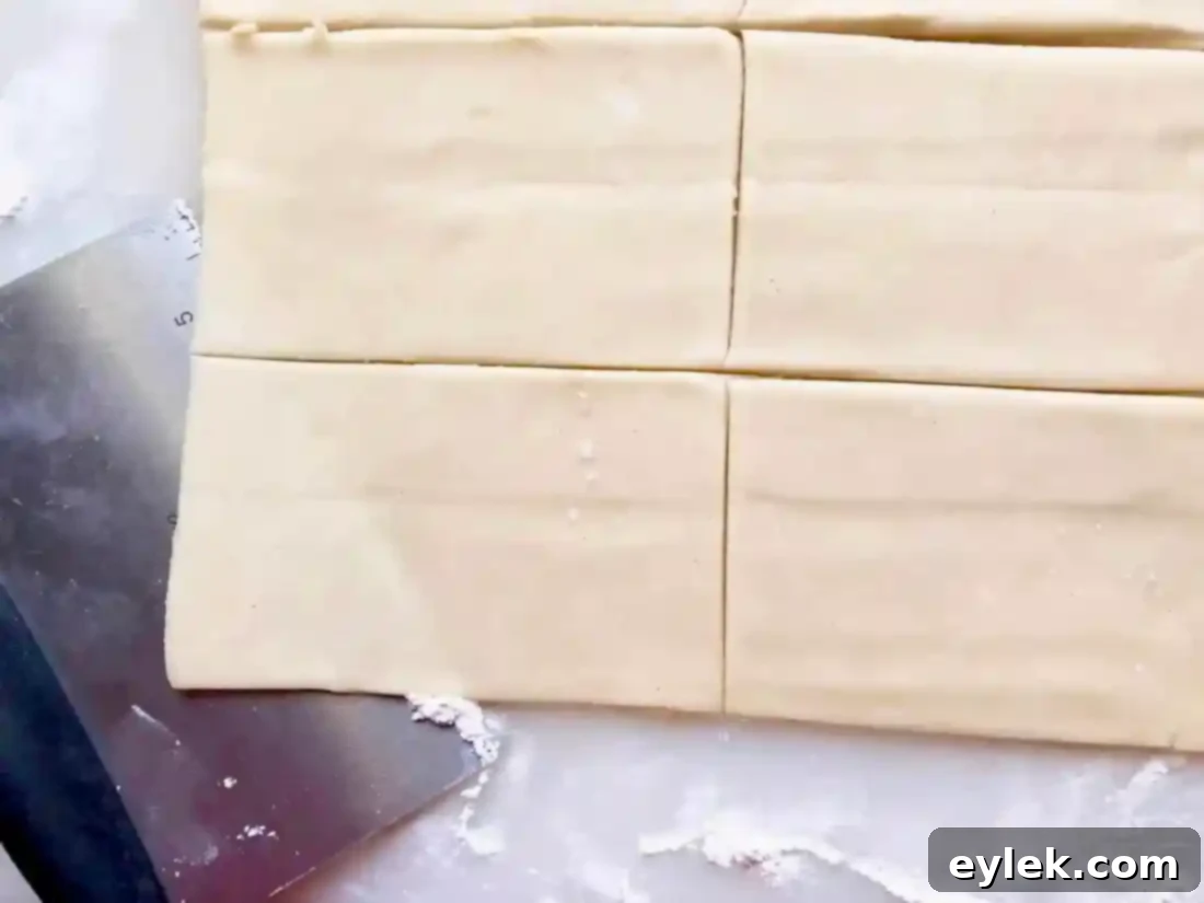 cutting pastry dough for ham & cheese slab pie