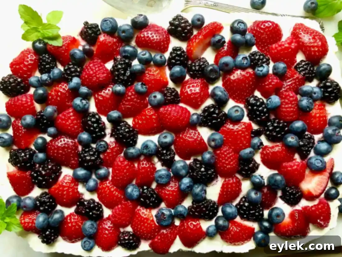 Sprinkling fresh berries over chilled cheesecake